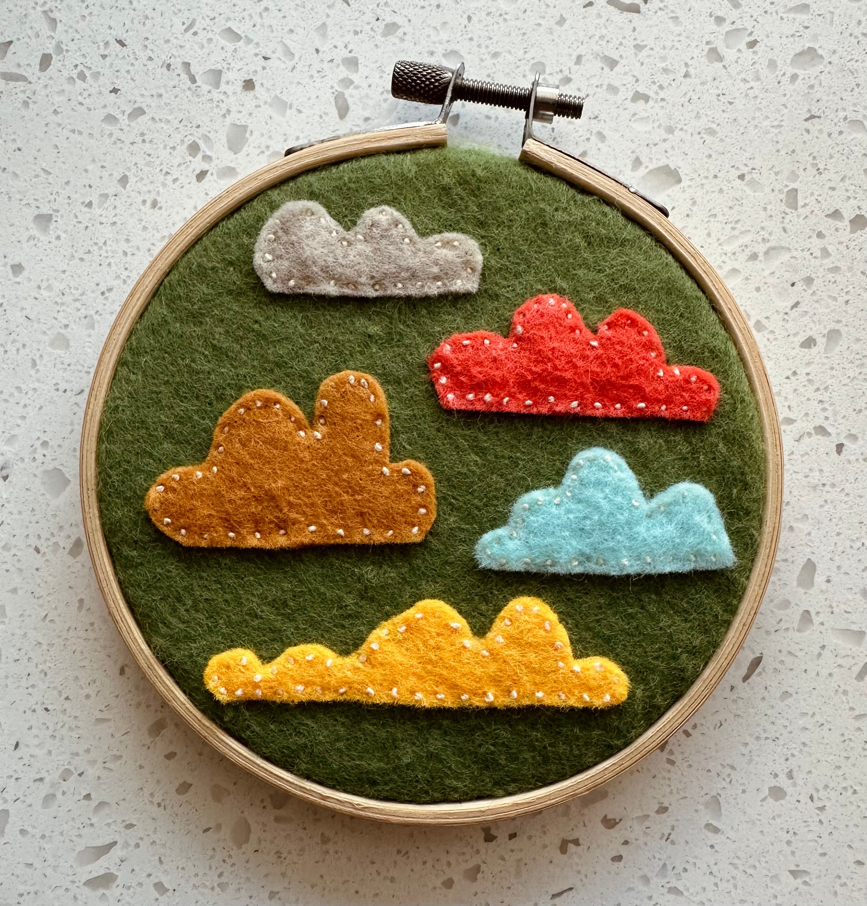 Felt cloud embroidery on hoop, green