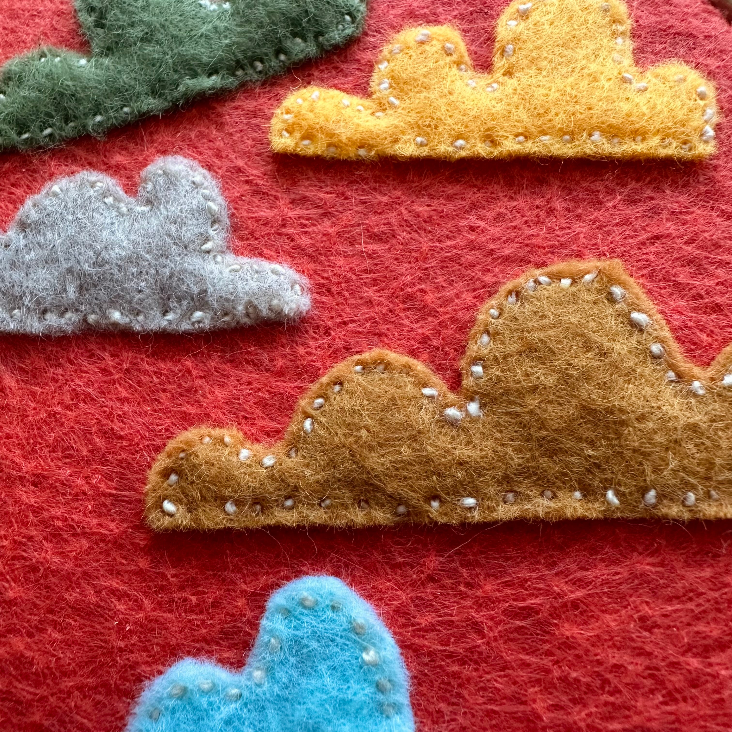 Felt cloud embroidery on hoop, orange