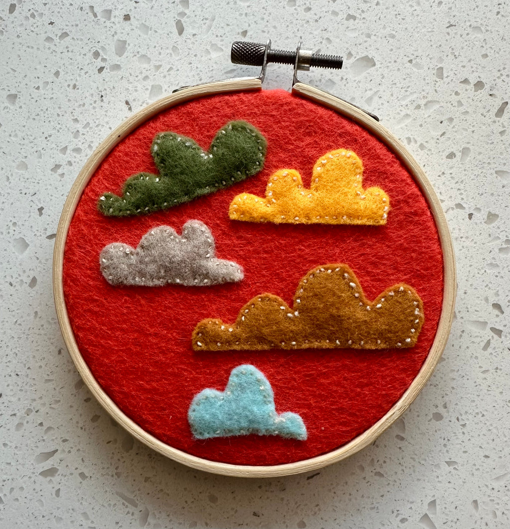 Felt cloud embroidery on hoop, orange