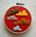 Felt cloud embroidery on hoop, orange